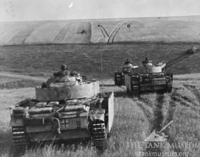 German Panzer IIIs fitted with Schurzen add-on armor on the move.