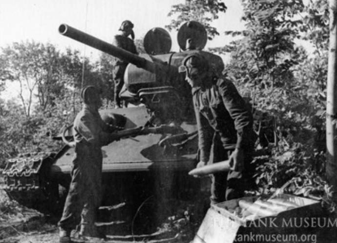 Loading 76.2mm ammunition into a T-34.