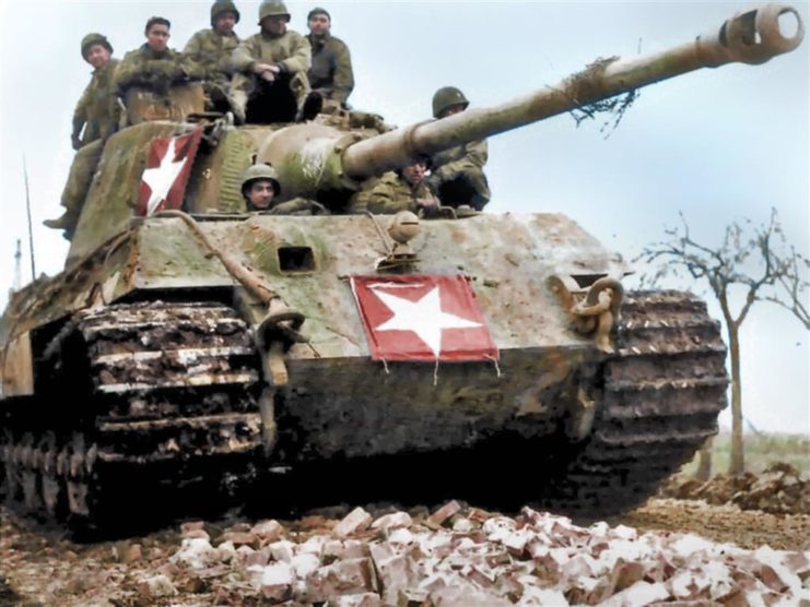 COLOURED photographs of army tanks during World War II in Nazi Germany show just how the arms race to develop the ultimate tank progressed for all sides during this most devastating of conflicts. The spectacular pictures reveal infantrymen with a tank of the 11th Armoured Division, 3rd US Army advancing through a smoke-filled street in Germany, while another image depicts the more basic M4A3 Sherman tank advancing into the center of Kronach in April, 1945. Other photographs show German artillerymen shoot Soviet tanks, while another exposes a more technically advanced and fearsome snow-covered German Panzer tank being used by two German soldiers. Further colourised images unfold the consequences of operating an army tank in the middle of a flood with a soldier trailing through the water on his motorcycle. The incredible pictures were brought to life by Royston Leonard (55), an electrician from Wales, UK, who took the time to carefully colourise the photographs, highlighting the true occurrence of the war and the weapons used. Royston Leonard / mediadrumworld.com