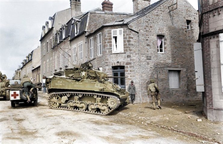 COLOURED photographs of army tanks during World War II in Nazi Germany show just how the arms race to develop the ultimate tank progressed for all sides during this most devastating of conflicts. The spectacular pictures reveal infantrymen with a tank of the 11th Armoured Division, 3rd US Army advancing through a smoke-filled street in Germany, while another image depicts the more basic M4A3 Sherman tank advancing into the center of Kronach in April, 1945. Other photographs show German artillerymen shoot Soviet tanks, while another exposes a more technically advanced and fearsome snow-covered German Panzer tank being used by two German soldiers. Further colourised images unfold the consequences of operating an army tank in the middle of a flood with a soldier trailing through the water on his motorcycle. The incredible pictures were brought to life by Royston Leonard (55), an electrician from Wales, UK, who took the time to carefully colourise the photographs, highlighting the true occurrence of the war and the weapons used. Royston Leonard / mediadrumworld.com