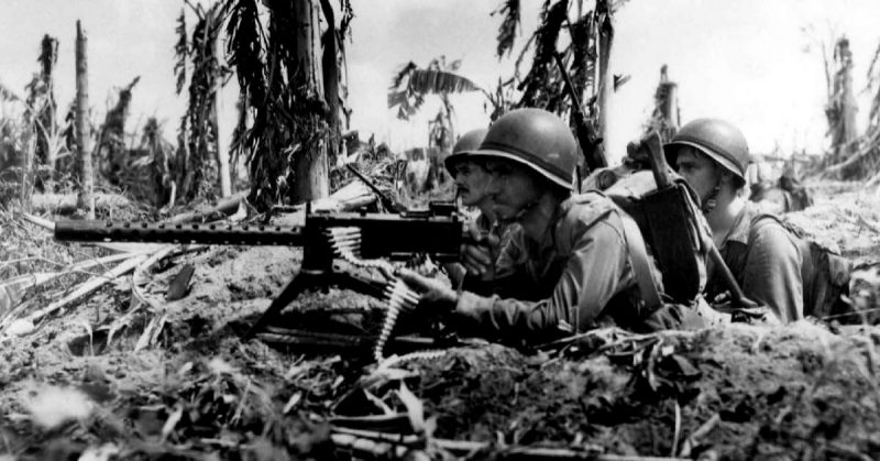 Marines operate their machine gun at Guam, 1944. 