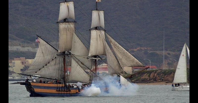 The modern replica of HMS Surprise takes part in a battle reenactment. 