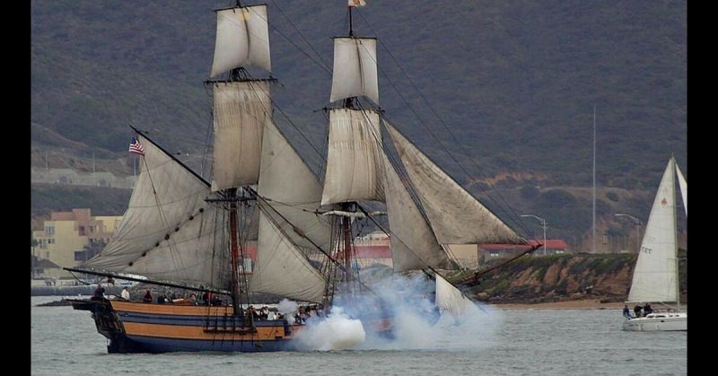 The modern replica of HMS Surprise takes part in a battle reenactment. 