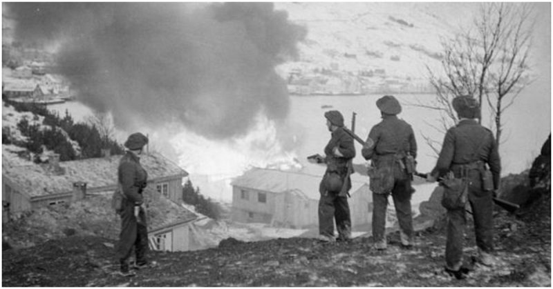 Commandos watching a burning munitions dump