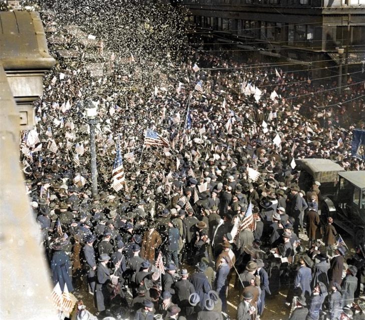 Crowds in New York celebrate the end of the First World War. Photo colourised by Royston Leonard / mediadrumworld.com