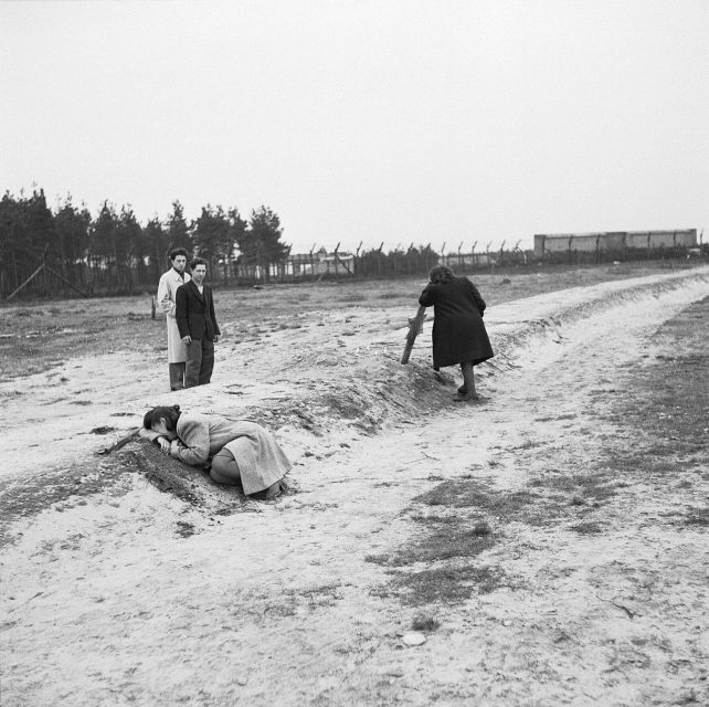 The First Anniversary of the Liberation of Bergen-belsen Concentration Camp, April 1946 Two former women inmates weep over one of the mass graves.
