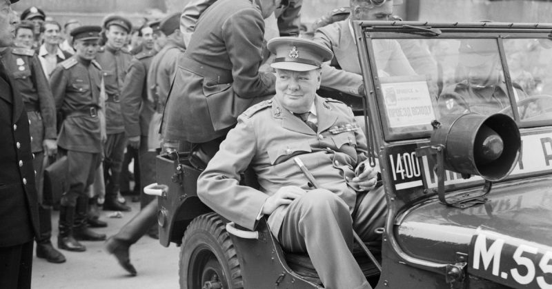  Prime Minister Winston Churchill sits in a jeep outside the Reichstag during a tour of the ruined city of Berlin, Germany on 16 July 1945.