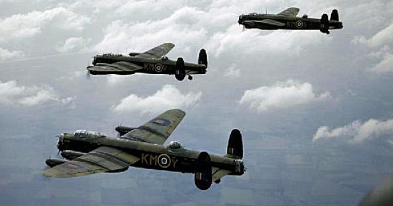 Three Avro Lancaster B.Is of No. 44 Squadron, Royal Air Force, based at Waddington, Lincolnshire (UK), flying above the clouds. 