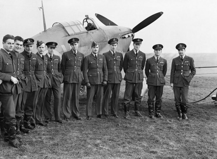 Pilots of No. 1 Squadron RCAF with one of their Hawker Hurricanes at Prestwick, Scotland, 30 October 1940.