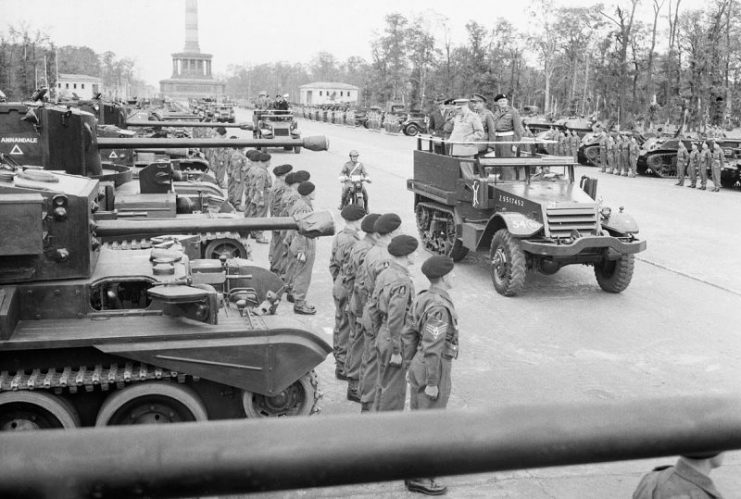 Prime Minister Winston Churchill, accompanied by Field Marshal Sir Bernard Montgomery and Field Marshal Sir Alan Brooke, inspects tanks of the “Desert Rats” from a half-track vehicle which moved slowly along the long line of troops and armor, during the British Victory parade in Berlin, 21 July 1945.