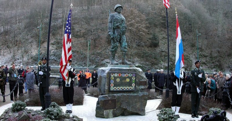 Soldiers, Sailors and World War II veterans remember those killed in action during the “Battle of the Bulge” at a wreath laying ceremony at the American GI Statue honoring the Liberation of Clervaux, Luxembourg. U.S. Navy photo by Photographer’s Mate 1st Class Ted Banks (released)