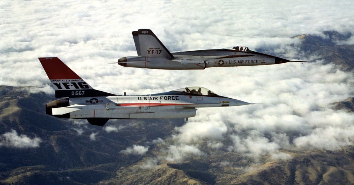 A right-side view of a YF-16 (foreground) and a Northrop YF-17, each armed with AIM-9 Sidewinder missiles
