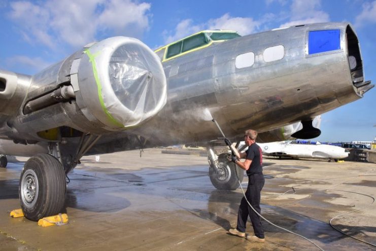 Museum restoration specialist Brian Lindamood, cleans the B-17F Memphis Belle in preparation for painting. (U.S. Air Force photo by Ken LaRock)