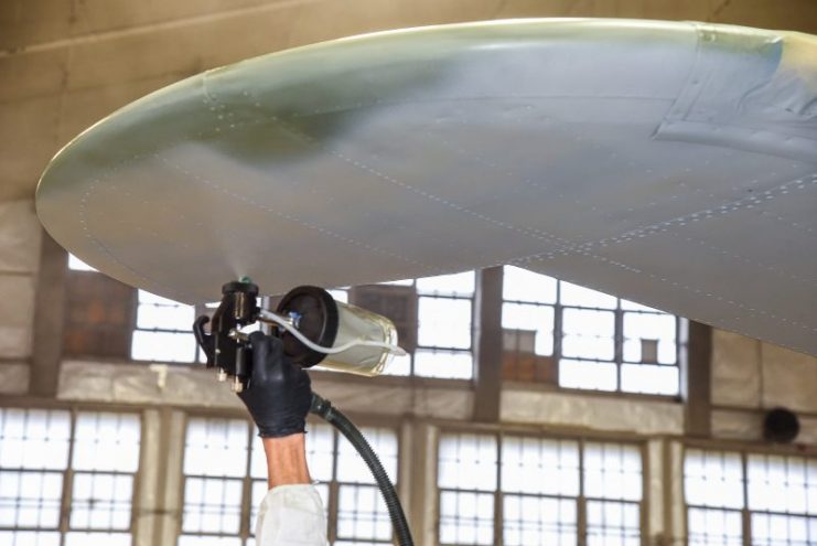 Painting the undersurface of the starboard horizontal stabilizer. (U.S. Air Force photo by Ken LaRock)