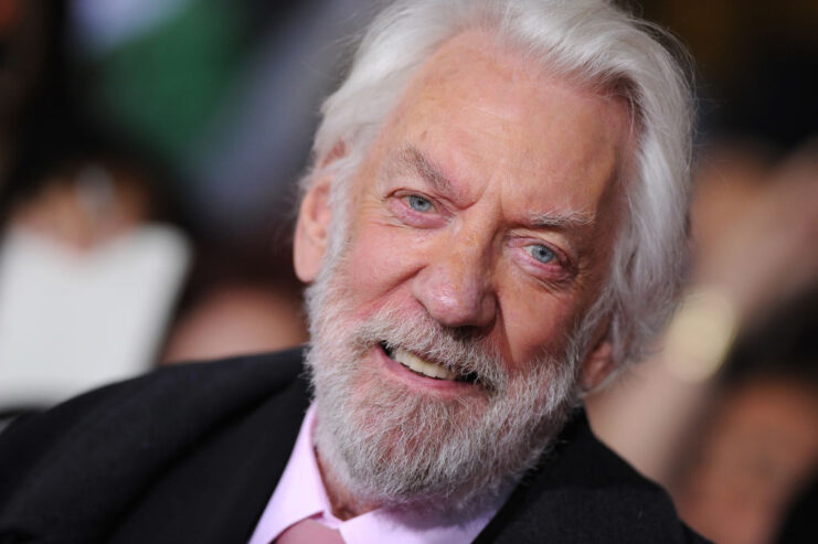 Donald Sutherland standing on a red carpet