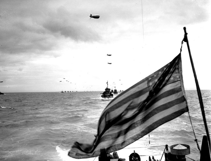 US Coast Guard Landing Craft Infantry (LCI) sailing beneath barge balloons