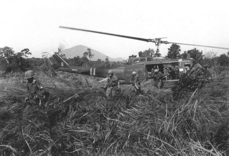 Infantrymen attacking out of a Huey during Operation Attleboro, Vietnam.