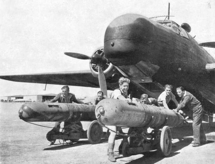 Loading 21″ RNTF Mark VIII torpedoes into a Vickers Wellington medium bomber, May 1942.