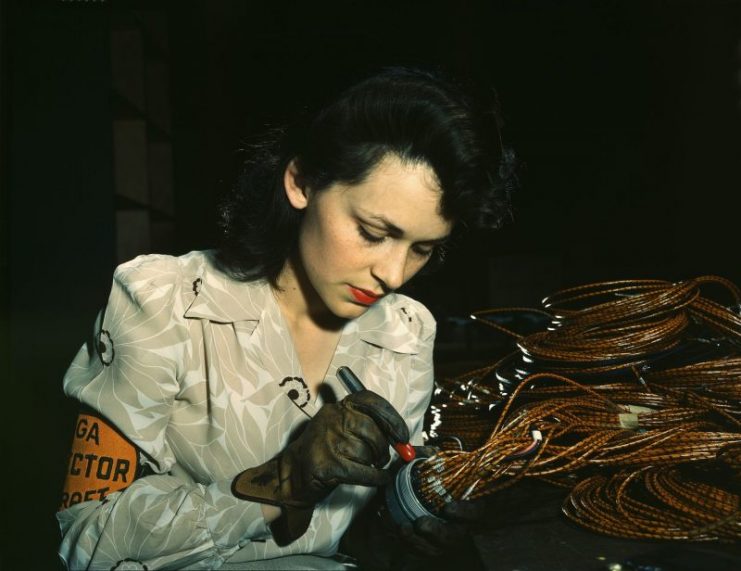 Woman aircraft worker checking assemblies. California, 1942.