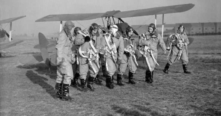 The first pilots of the ATA Womens’ Section pilots walking past newly-completed De Havilland Tiger Moths awaiting delivery to their units at Hatfield, Hertfordshire.