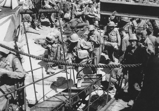 Official U.S. Army photograph, taken a Pozzuoli near Naples in August 1944, that happened to capture Private First Class Steve Weiss boarding a British landing craft. He is climbing the gangplank on the right-hand side of the photograph.