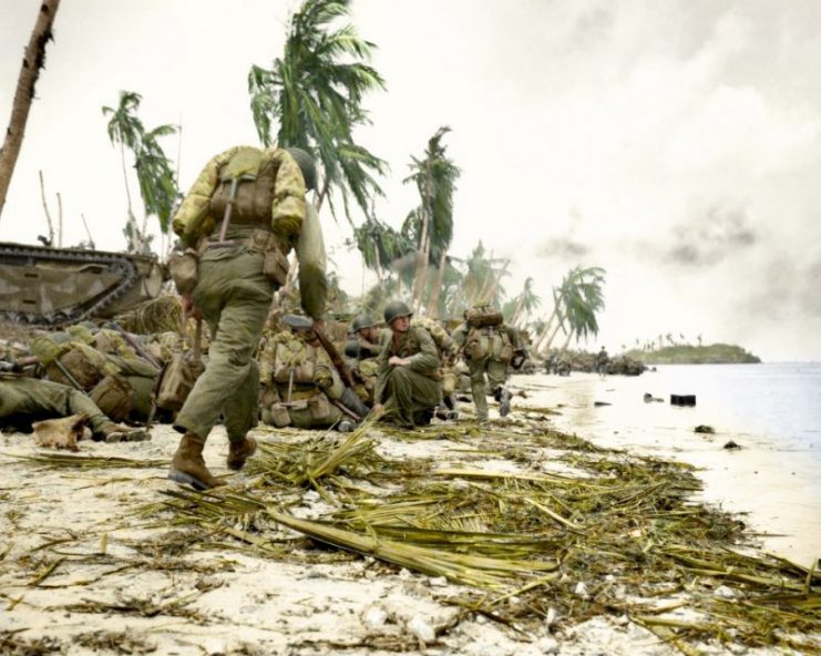 First assault waves of Marines take cover prior to moving inland on Guam. 1944. Paul Reynolds / mediadrumworld.com