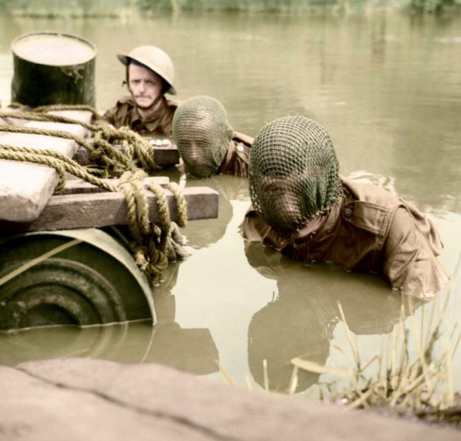 Members of the Doncaster Home Guard, two wearing camouflage net veils over their faces, swim across a river during an assault exercise, 20 July 1942. Paul Reynolds / mediadrumworld.com