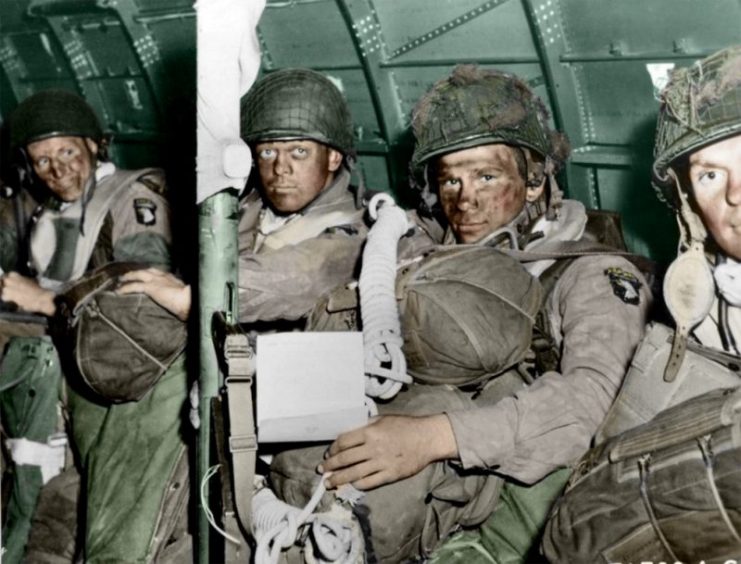 101st Airborne D-Day C47 – Resolute faces of paratroopers just before they took off for the initial assault of D-Day, June 6, 1944. The paratrooper in the foreground has just read General Eisenhower’s message of good luck and clasps his bazooka in the other hand. Paul Reynolds / mediadrumworld.com