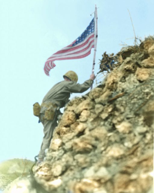 US Flag raised over Shuri castle on Okinawa. Braving Japanese sniper fire, US Marine Lieutenant Colonel R.P. Ross, Jr. places on American flag on a parapet of Shuri castle on May 29, 1945. The castle is a former enemy stronghold in southern Okinawa in the Ryukyu (Loochoo chain), situated 375 miles from Japan. Paul Reynolds / mediadrumworld.com