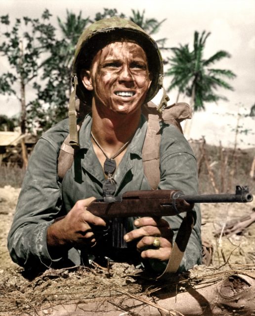 Marine with M1 Carbine awaits signal to go ahead in battle to recapture Guam from Japanese, 1944. Paul Reynolds / mediadrumworld.com