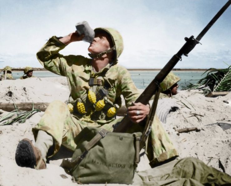 US Marine carrying extra ammunition and grenades during the Pacific Campaign of World War Two, Tarawa, Kiribati, circa 1941-1945. Paul Reynolds / mediadrumworld.com