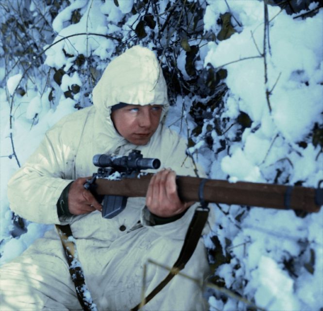 A 6th Airborne Division sniper on patrol in the Ardennes, wearing a snow camouflage suit, 14 January 1945. Paul Reynolds / mediadrumworld.com