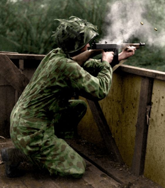 A US Marine wearing his camouflage suit fires a Thompson sub-machine gun during Jungle Training – 1942. Paul Reynolds / mediadrumworld.com