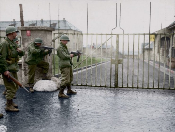 American infantrymen and tankmen shooting the lock on a prison gate before releasing Allied officers inside at the Hammelburg Prison, Germany, World War II. Paul Reynolds / mediadrumworld.com