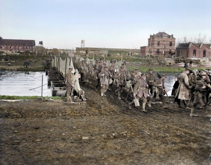 Men of the 55th (West Lancashire) Division cross a pontoon bridge over the Scheldt at Tournai, 9 November 1918. Royston Leonard / mediadrumworld.com