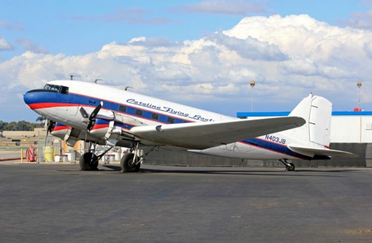 Photo above: Preferred has collected old DC-3/C-47 airframes from all over the mainland USA and Alaska that came in flying or by ship/ road transport, also from South Africa (The old “Dodson” Stock, and SAAF airframes from Wonderboom Airfield, Pretoria). There is an ex-KLM DC-3 N3BA and there are also two ex-Catalina Flying Boats Air Freight Service DC-3 airframes from San Diego, CA. The last one N403JB was flown in June 2017, still standing on the platform (see photo courtesy Michael Prophet) with original engines, waiting for a conversion but forever ending the commercial flights with the old DC-3s in the US Mainland Westcoast. They were replaced by the Cessna 208B Caravan (the Super Cargo Master), a high-wing monoplane, with max 13 passengers or 1,5-2 tons of payload, cruising at 200 knots.
