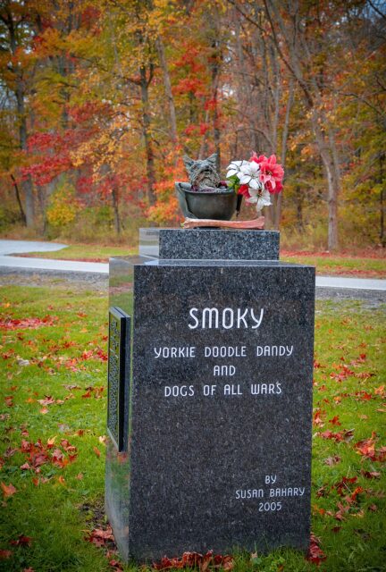 Monument featuring a statue of Smoky sitting in a military helmet