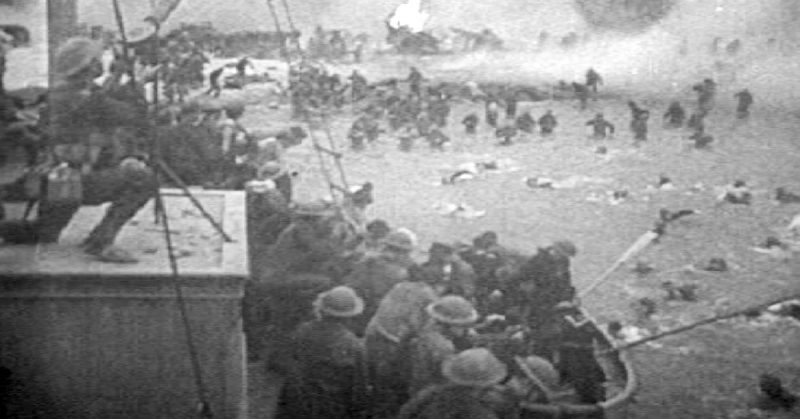 Feature film re-enactment of British troops under fire on the beach at Dunkirk.
