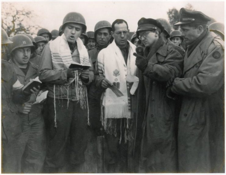Max Fuchs (left in prayer shawl) singing in Aachen, Germany during the first Jewish service to be held on German soil since the rise of Hitler, which was broadcast on NBC. Rabbi Chaplain Sidney Lefkowitz is next to him. Oct. 29, 1944. Courtesy Max Fuchs.