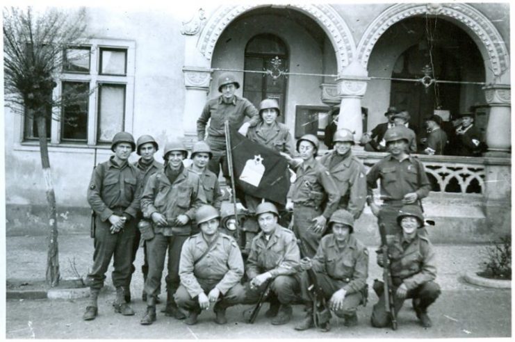 Group around Jewish chaplain’s flag, Written on back: “end of war for 104th Inf. 1945.” Courtesy National Museum of American Jewish Military History