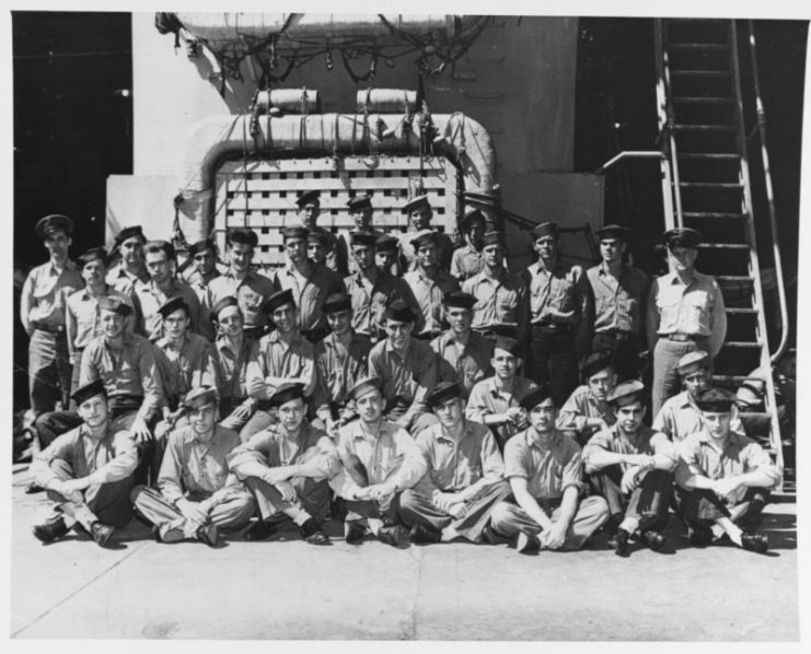 USS Indianapolis (CA-35). Members of the ship’s crew pose in the well deck, during World War II. Official U.S. Navy Photograph, now in the collections of the National Archives.