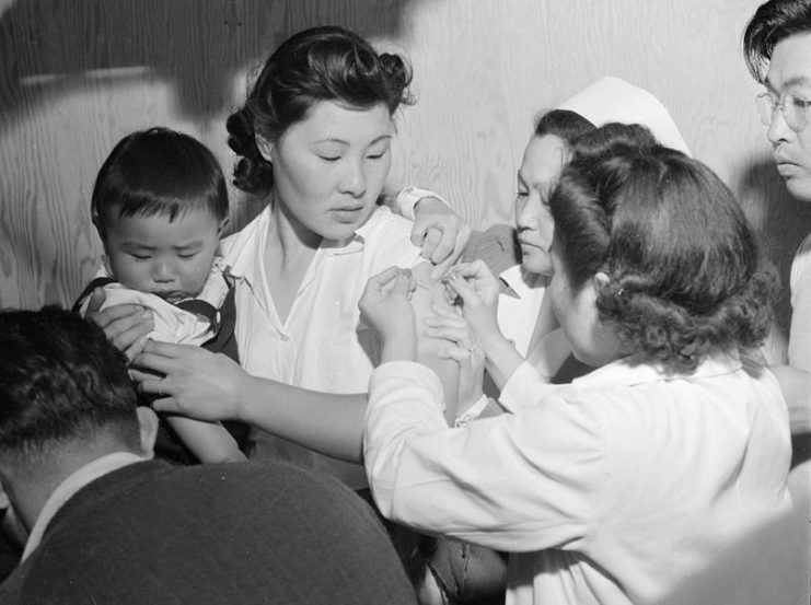 Japanese-American woman being vaccinated at the assembly center in Arcadia, California, United States, 1942.