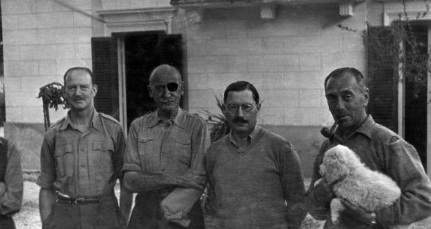 From left: Brigadier John Combe, Major-General Adrian Carton de Wiart, Brigadier Edward Todhunter & Major-General Michael Gambier-Parry (camp forger) holding puppy Mickey.