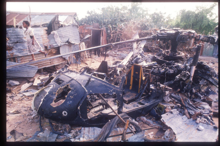 Children playing on the wreck of a downed US helicopter