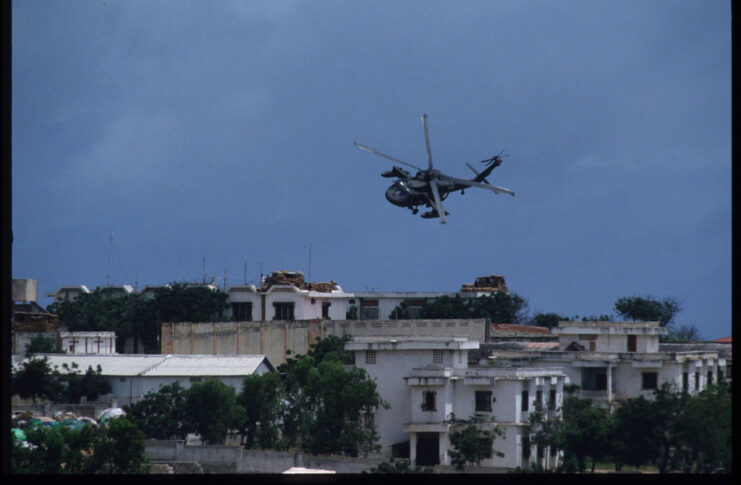 US helicopter flying over a refugee camp