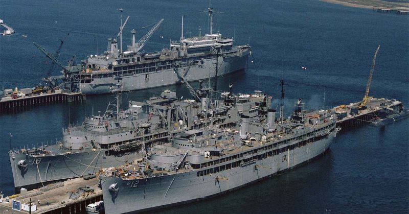 The U.S. Navy submarine tenders USS Sperry (AS-12), right, and USS Proteus (AS-19) docked at Ballast Point, San Diego, California (USA), on 24 January 1985. The submarine tender USS Dixon (AS-37) is docked in the background.