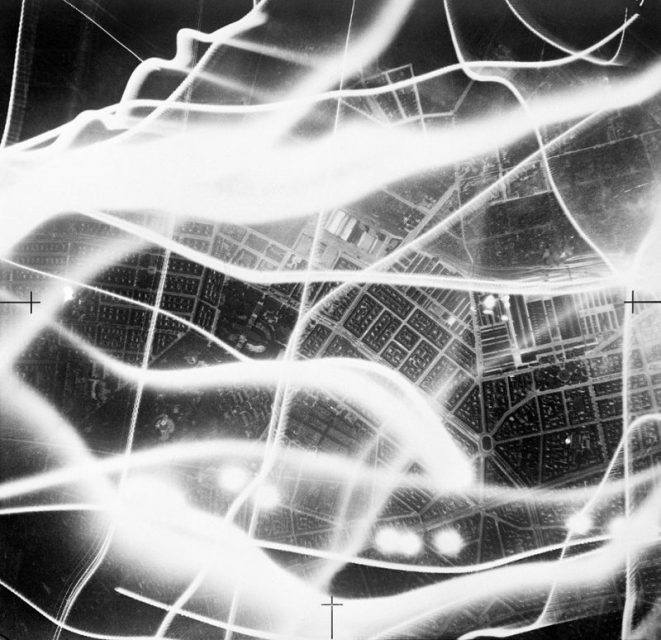 A vertical aerial photograph taken during a raid on Berlin on the night of 2/3 September 1941. The broad wavy lines are the tracks of German searchlights and anti-aircraft fire.