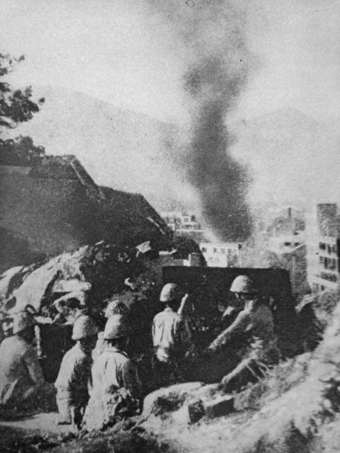 Japanese artillerymen looking toward Hong Kong