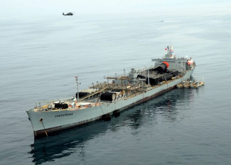 The RRF offshore petroleum discharge systems ship ST Chesapeake (AOT-5084), activated for this exercise, is anchored off the coast of Red Beach in Camp Pendelton, CA., 22 July 2008, as an UH-60 Blackhawk helicopter flies over head during Joint Logistics Over-The-Shore (JLOTS) 2008. JLOTS 2008 is an engineering, logistical training exercise between Army and Navy units under a joint force commander (JFC) as a means to load and unload ships without the benefit of deep draft-capable, fixed port facilities.US Navy photo # 080722-N-1424C-538 PACIFIC OCEAN (July 22, 2008) by MC2 Brian P. Caracci.