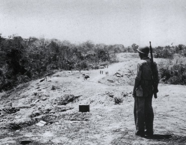 US Marine looking at fighting positions along Hill 123